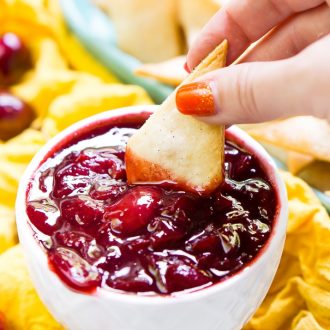 This Cherry Pie Dip is all the deliciousness of the classic pie but easier to make and perfect for parties! Fresh cherries are simmered into a thick and gooey dip served with cinnamon sugar pie chips!