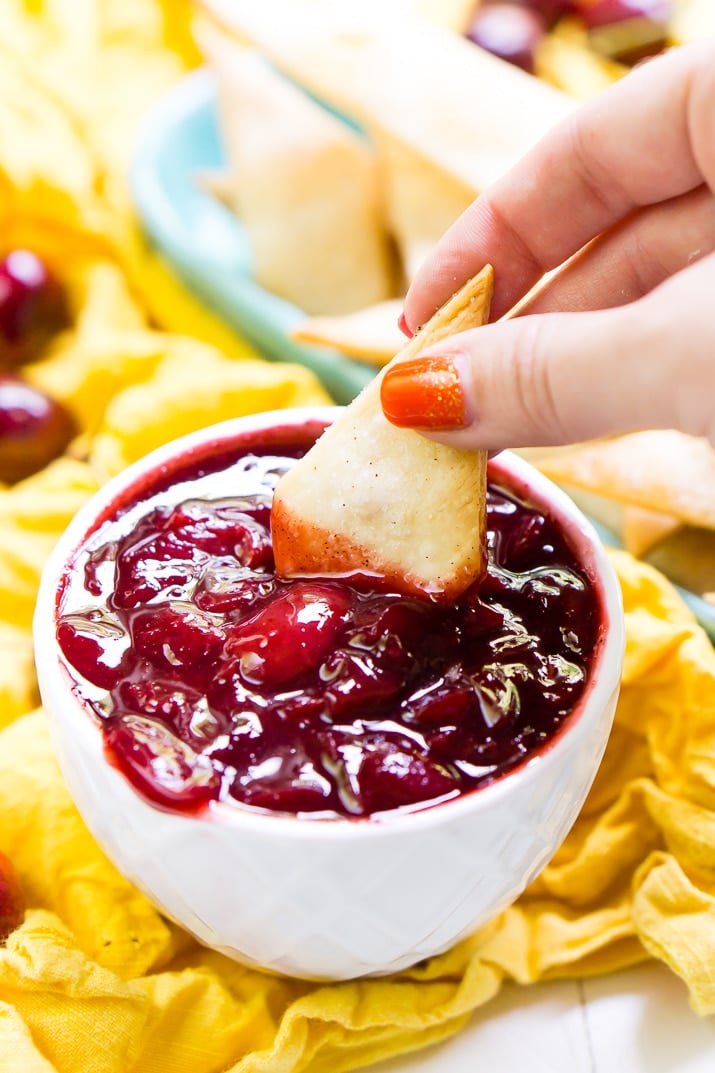 This Cherry Pie Dip is all the deliciousness of the classic pie but easier to make and perfect for parties! Fresh cherries are simmered into a thick and gooey dip served with cinnamon sugar pie chips!