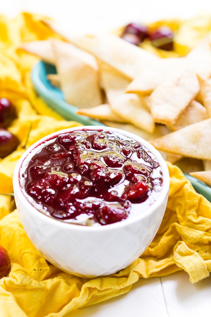 This Cherry Pie Dip is all the deliciousness of the classic pie but easier to make and perfect for parties! Fresh cherries are simmered into a thick and gooey dip served with cinnamon sugar pie chips!
