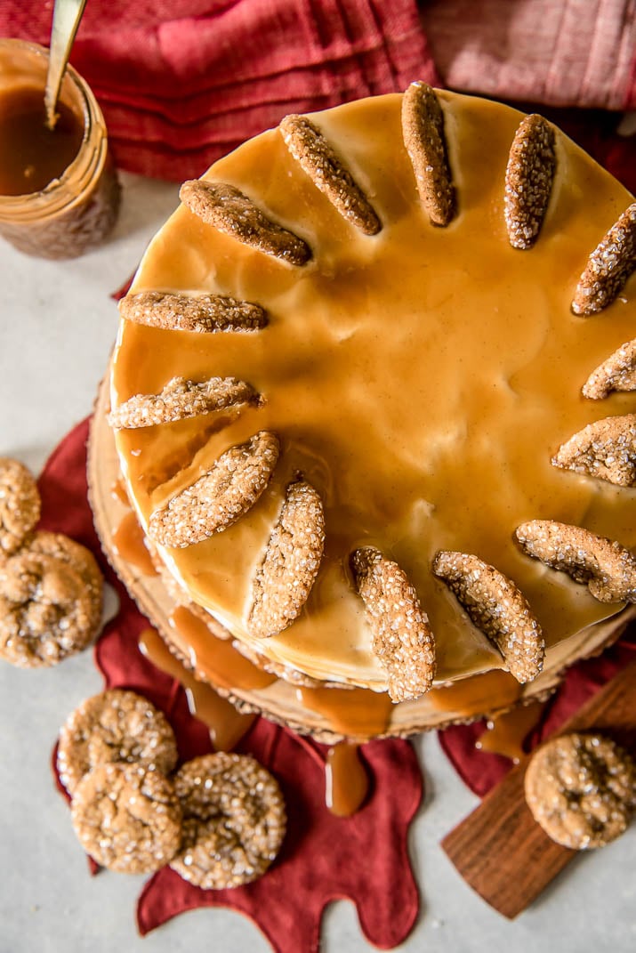 Seasonal and comforting, this Boozy Bourbon Caramel Spice Cake is full of fall flavors, covered in a caramel bourbon cream cheese buttercream, and garnished with your favorite gingersnap cookies!