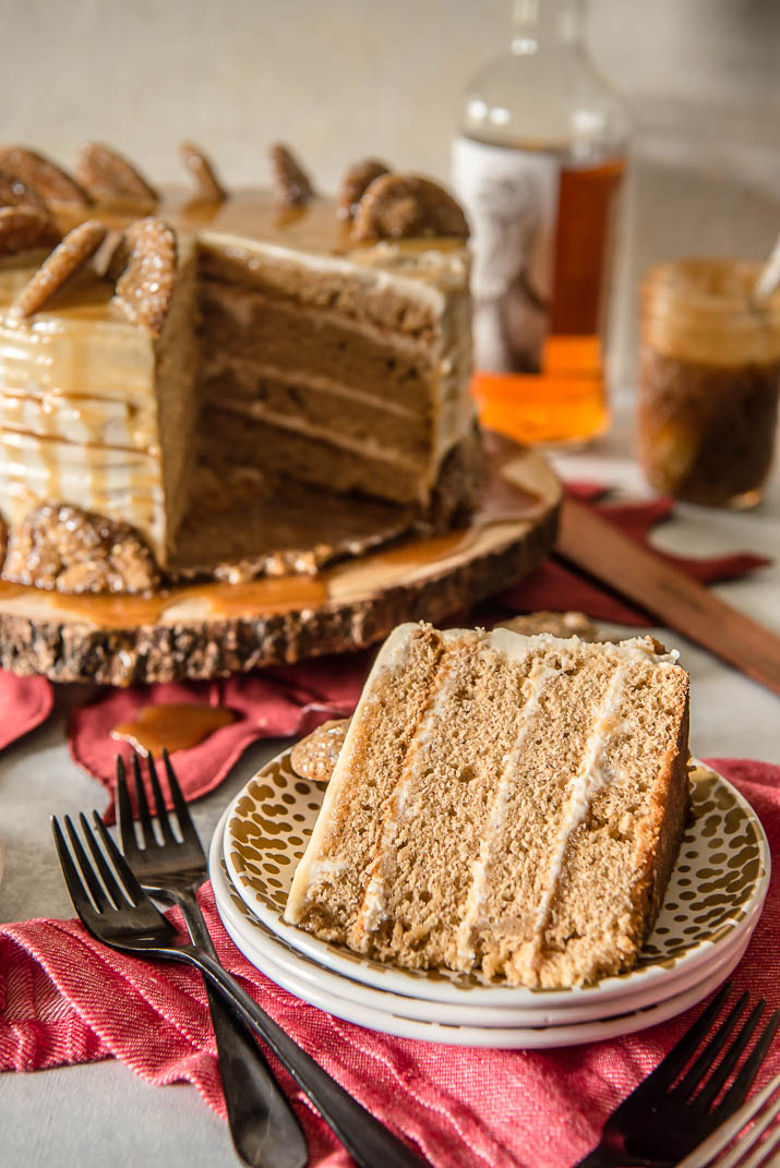 Seasonal and comforting, this Boozy Bourbon Caramel Spice Cake is full of fall flavors, covered in a caramel bourbon cream cheese buttercream, and garnished with your favorite gingersnap cookies!