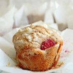 These Raspberry White Chocolate Chip Muffins are made with whole wheat flour. They are so soft and fluffy, and bursting with fresh raspberries! | wildwildwhisk.com
