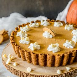 Present that traditional pumpkin pie in a more festive way with this White Chocolate Pumpkin Cheesecake Tart! Pumpkin cheesecake, infused with white chocolate and nestled in a gingersnap crust, is going to be your new favorite holiday dessert!