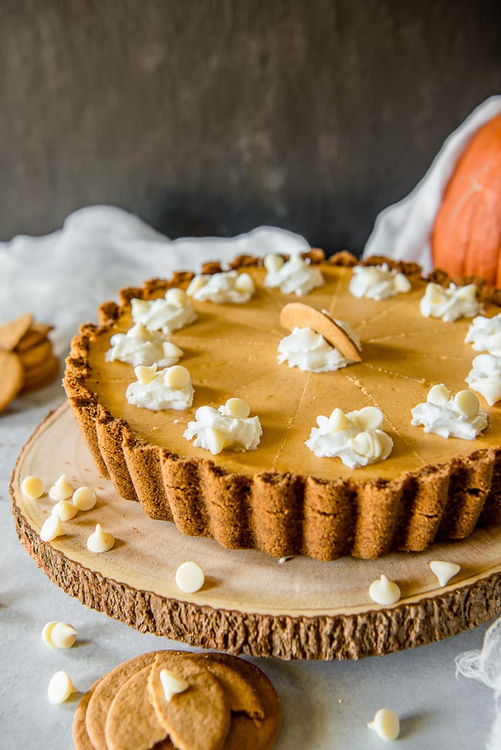 Present that traditional pumpkin pie in a more festive way with this White Chocolate Pumpkin Cheesecake Tart! Pumpkin cheesecake, infused with white chocolate and nestled in a gingersnap crust, is going to be your new favorite holiday dessert!