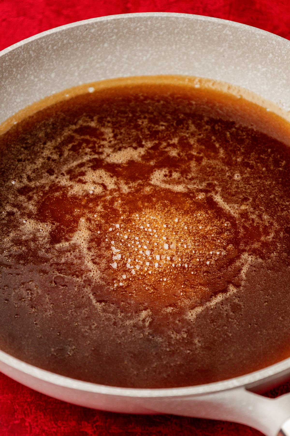 Sugar and water simmering in a skillet.