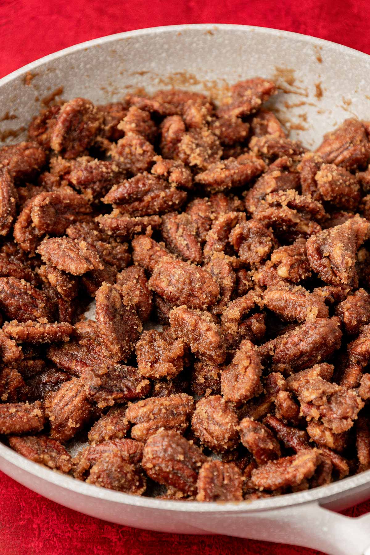 Candied pecans in a skillet.