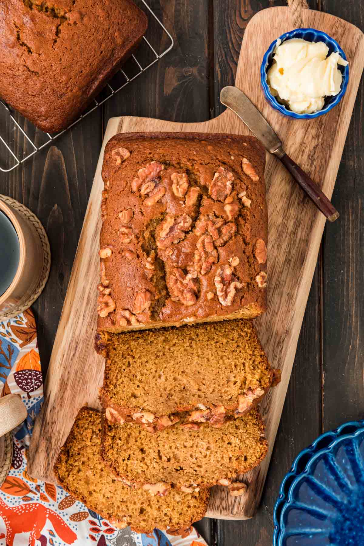 Overhead photo of Downeast Pumpkin Bread sliced on a wooden cutting board.