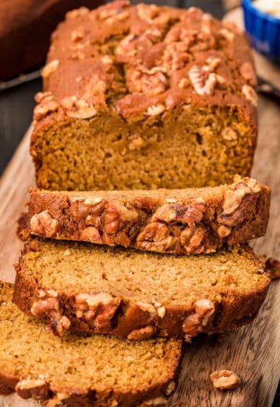 Close up of a partially sliced loaf of pumpkin bread.