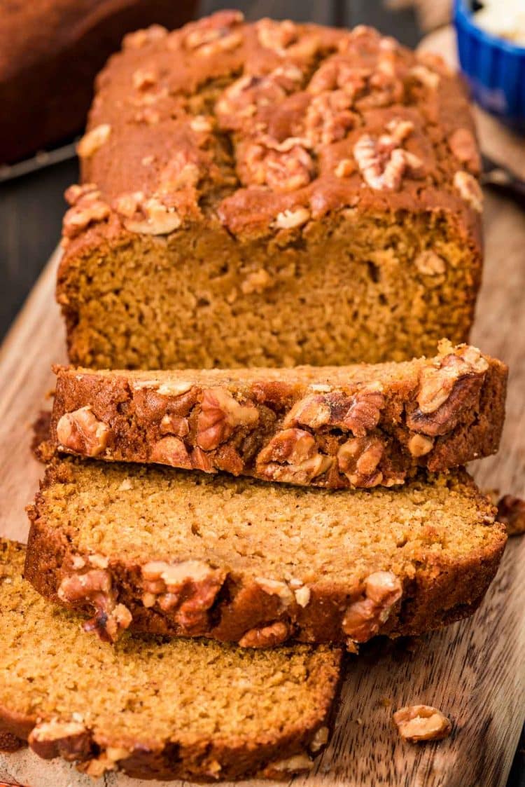 Close up of a partially sliced loaf of pumpkin bread.
