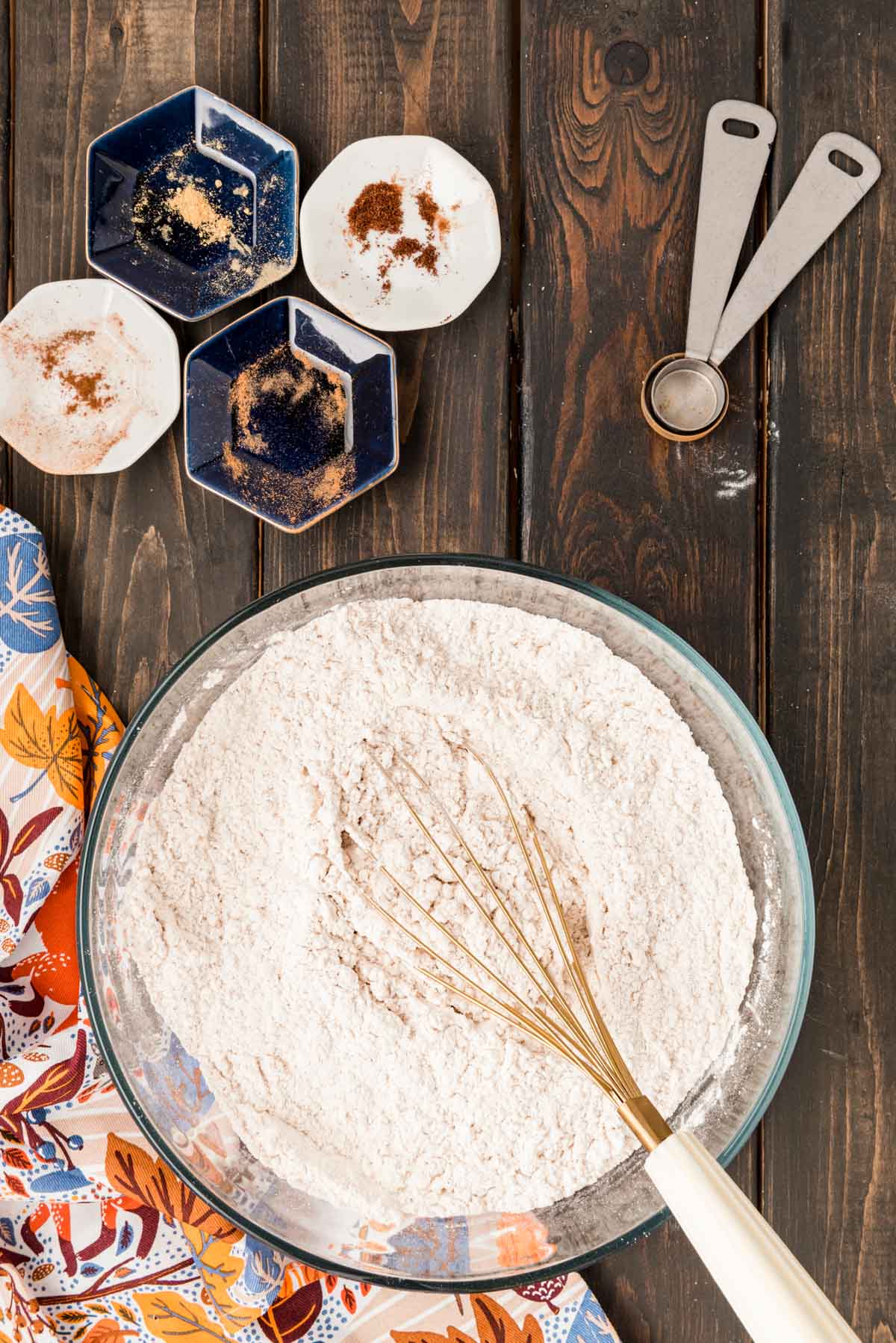 Dry ingredients being whisked in a glass bowl.