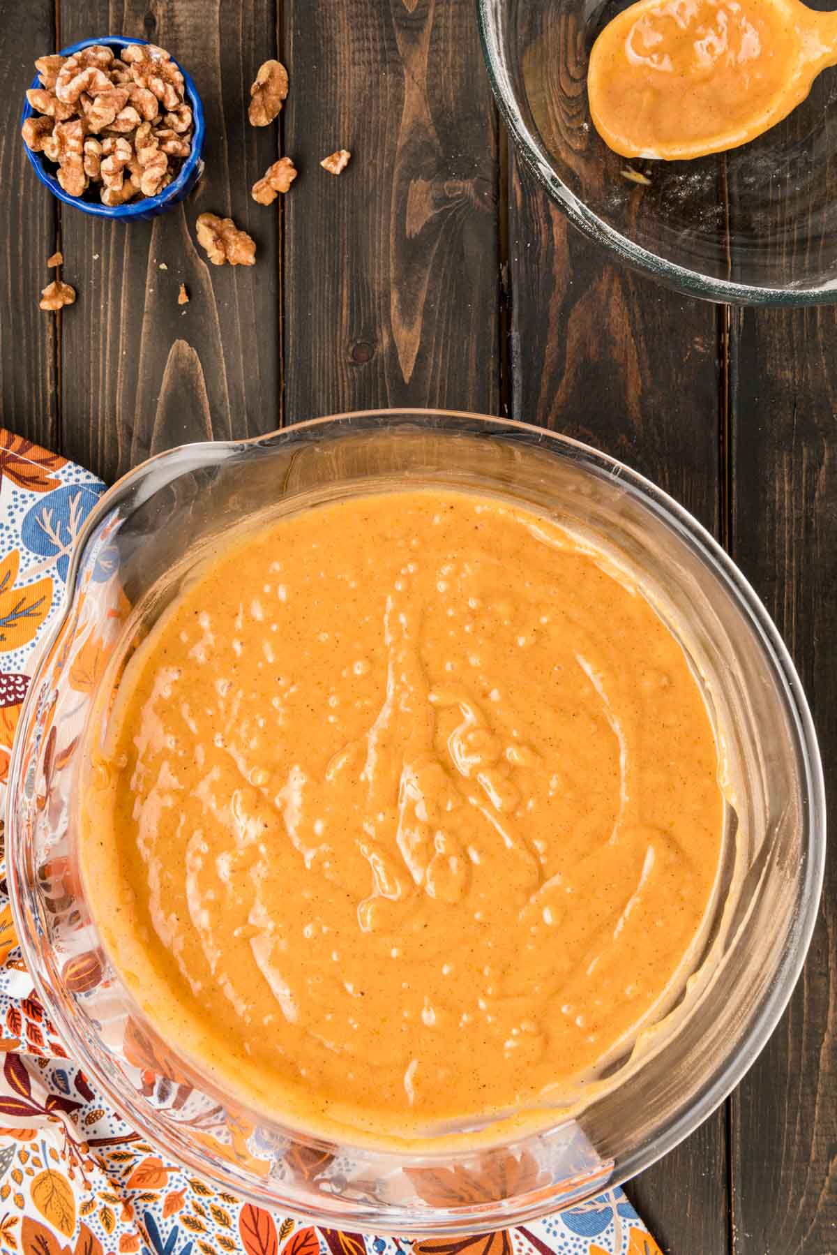 Pumpkin bread batter in a glass mixing bowl.