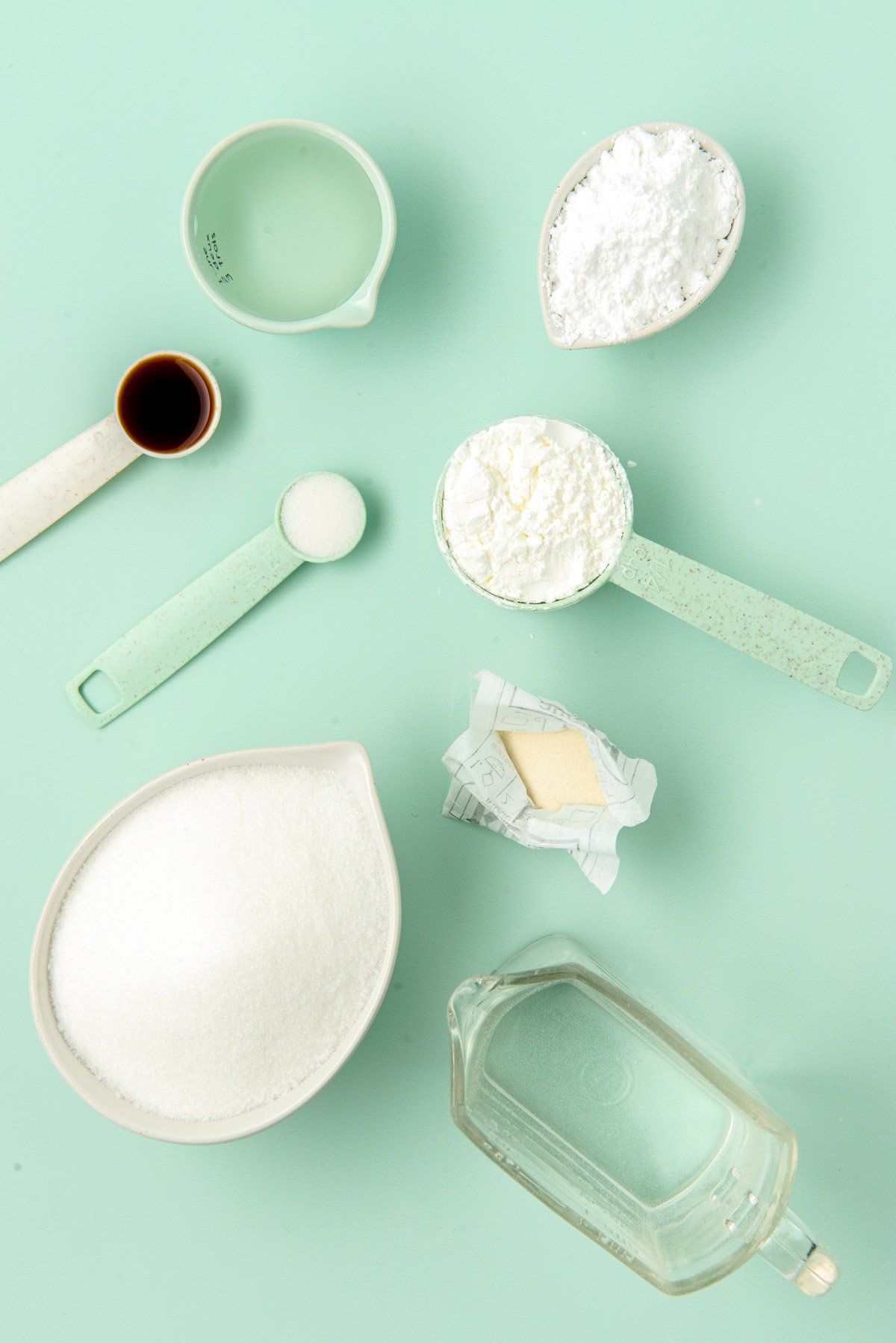 Ingredients to make homemade marshmallows on a green table.