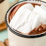 Homemade marshmallows in a white mug filled with hot chocolate.