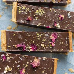 This is the creamiest dreamiest chocolate truffle tart that you will ever eat. Dark smooth chocolate, in a crispy flaky crust, topped with hazelnuts, pistachios and rose petals... and a little gold make this the perfect indulgent treat for any occasion.