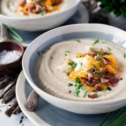 This Loaded Cauliflower Soup is creamy and delicious! It's made with fresh cauliflower, sweet onion, and topped with crispy bacon, cheddar cheese, and sour cream for a healthy meal option.