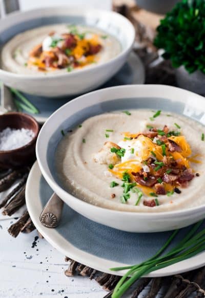 This Loaded Cauliflower Soup is creamy and delicious! It's made with fresh cauliflower, sweet onion, and topped with crispy bacon, cheddar cheese, and sour cream for a healthy meal option.