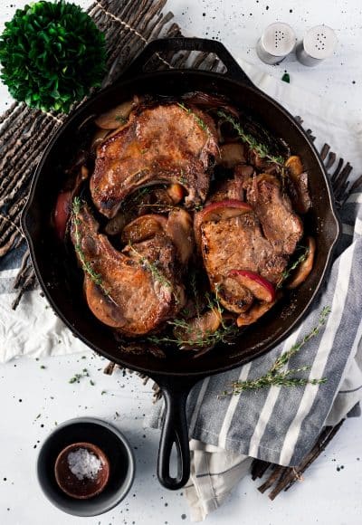 This Baked Pork Chops recipe will be an instant family dinner favorite! Made with wine, apples, and shallots, there's so much flavor in this pork recipe!