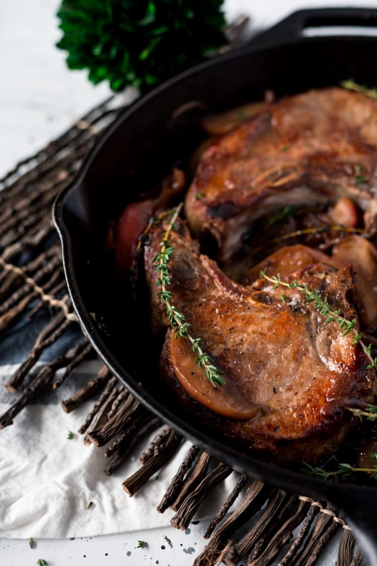 This Baked Pork Chops recipe will be an instant family dinner favorite! Made with wine, apples, and shallots, there's so much flavor in this pork recipe!