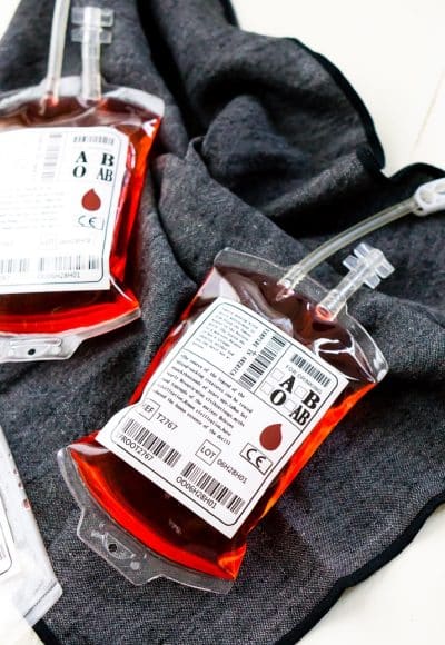 This Blood Bag Cocktail is the perfect quick drink for all your Halloween parties! Made with two ingredients, this drink is an easy and deliciously spooky libation!
