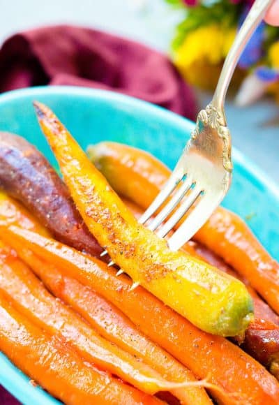 These Orange Braised Carrots are bound to be a highlight on your dinner table! Made with fresh-squeezed orange juice, butter, shallots, black pepper, and turmeric, this is one delicious side dish recipe!