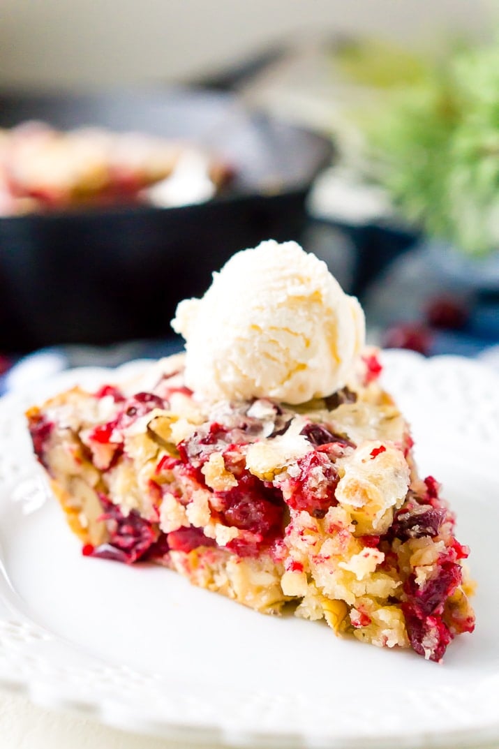 This Cranberry Cake combines sweet and tart in a delicious holiday dessert bursting with fresh red berries! A simple, old fashioned, single layer cake baked right in a skillet!