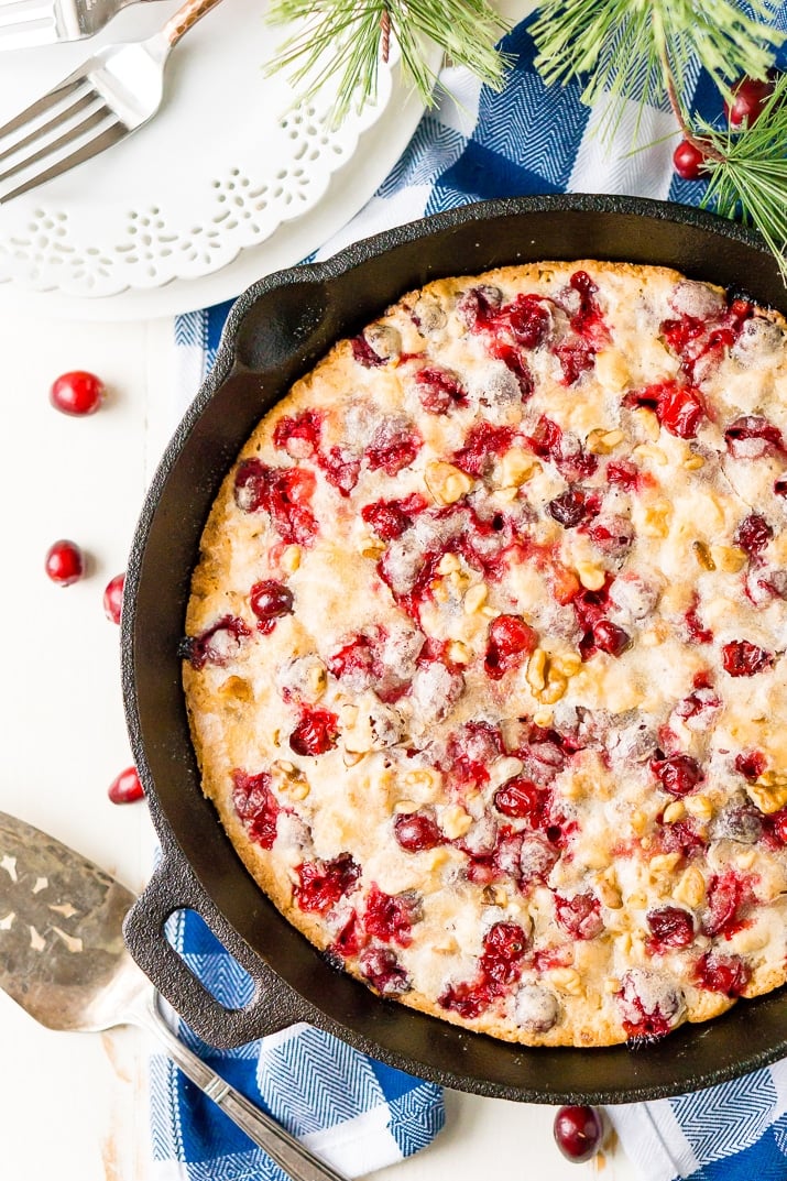 This Cranberry Cake combines sweet and tart in a delicious holiday dessert bursting with fresh red berries! A simple, old fashioned, single layer cake baked right in a skillet!