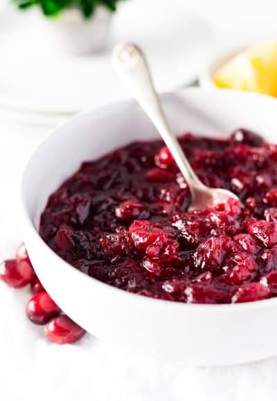 This Bourbon Orange Cranberry Sauce is loaded with tart and zesty flavor! Made with fresh cranberries, orange juice, orange zest, and bourbon on the stove and ready in less than 30 minutes.