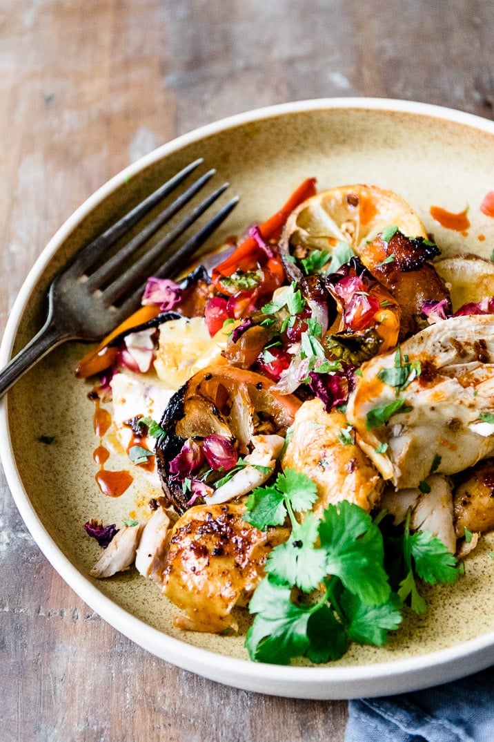 This spicy and aromatic Harissa chicken tray bake is a simple yet impressive dinner that will become a new family classic. Crispy golden skinned chicken, smothered with spicy Harissa paste and roasted on top of seasonal vegetables.