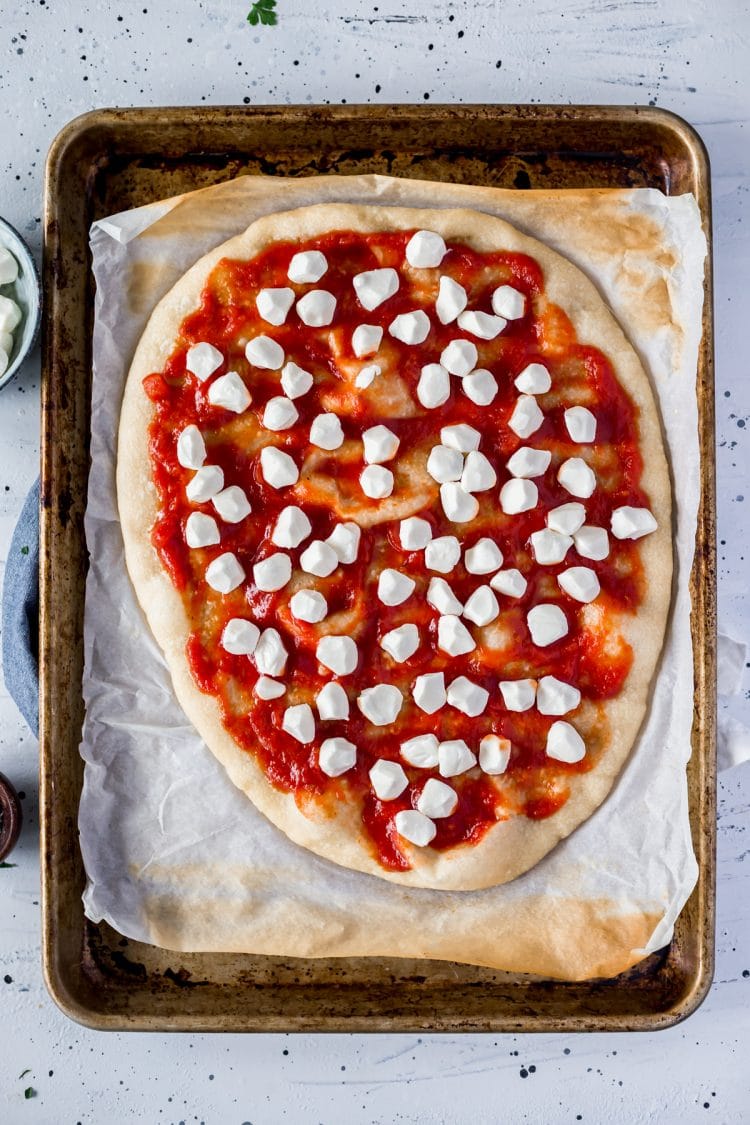 Sauce and mozzarella on Margherita Pizza