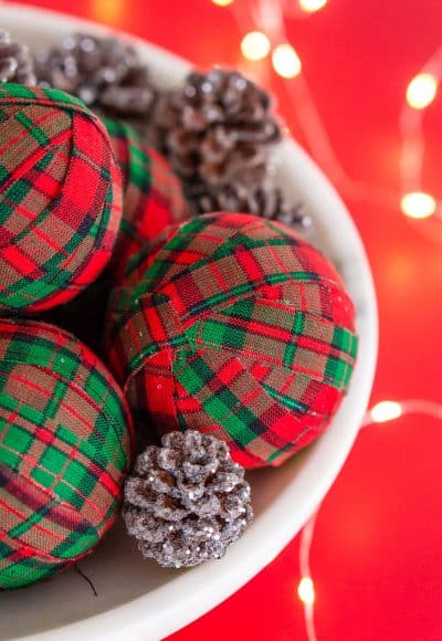 These DIY Holiday Rag Balls are a simple way to add a bit of holiday charm to your home. This craft project is super easy to make with just 4 materials! Makes great ornaments and party favors too!