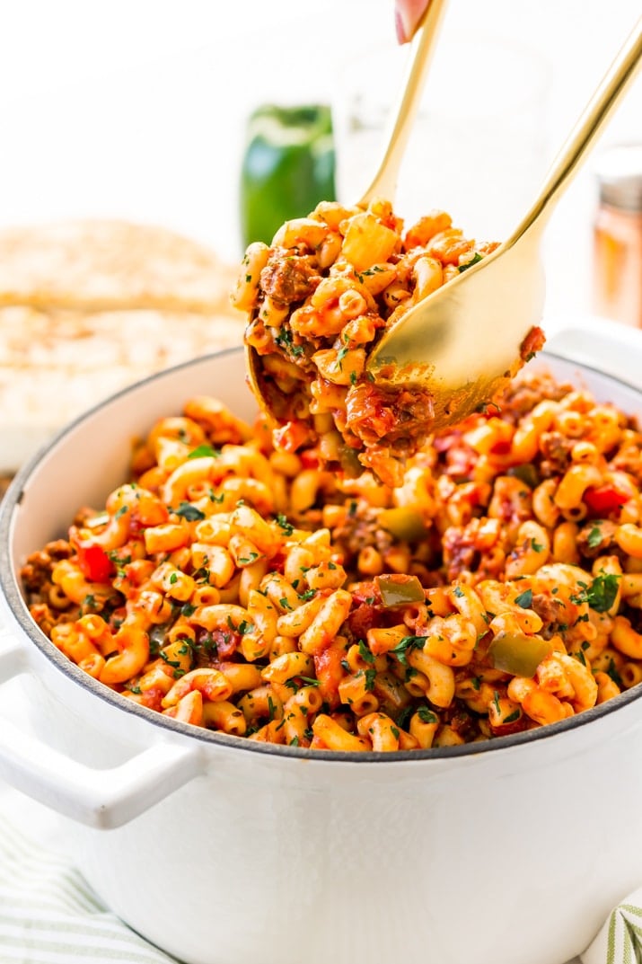 American Chop Suey is a delicious and easy dinner recipe made with ground beef, tomato, onion, green pepper, macaroni, and spices. Pure comfort food made on the stovetop in just 30 minutes and makes a great weeknight dinner!