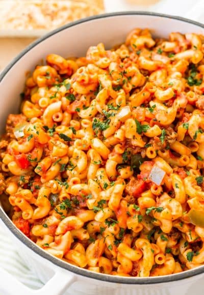 American Chop Suey is a delicious and easy dinner recipe made with ground beef, tomato, onion, green pepper, macaroni, and spices. Pure comfort food made on the stovetop in just 30 minutes and makes a great weeknight dinner!