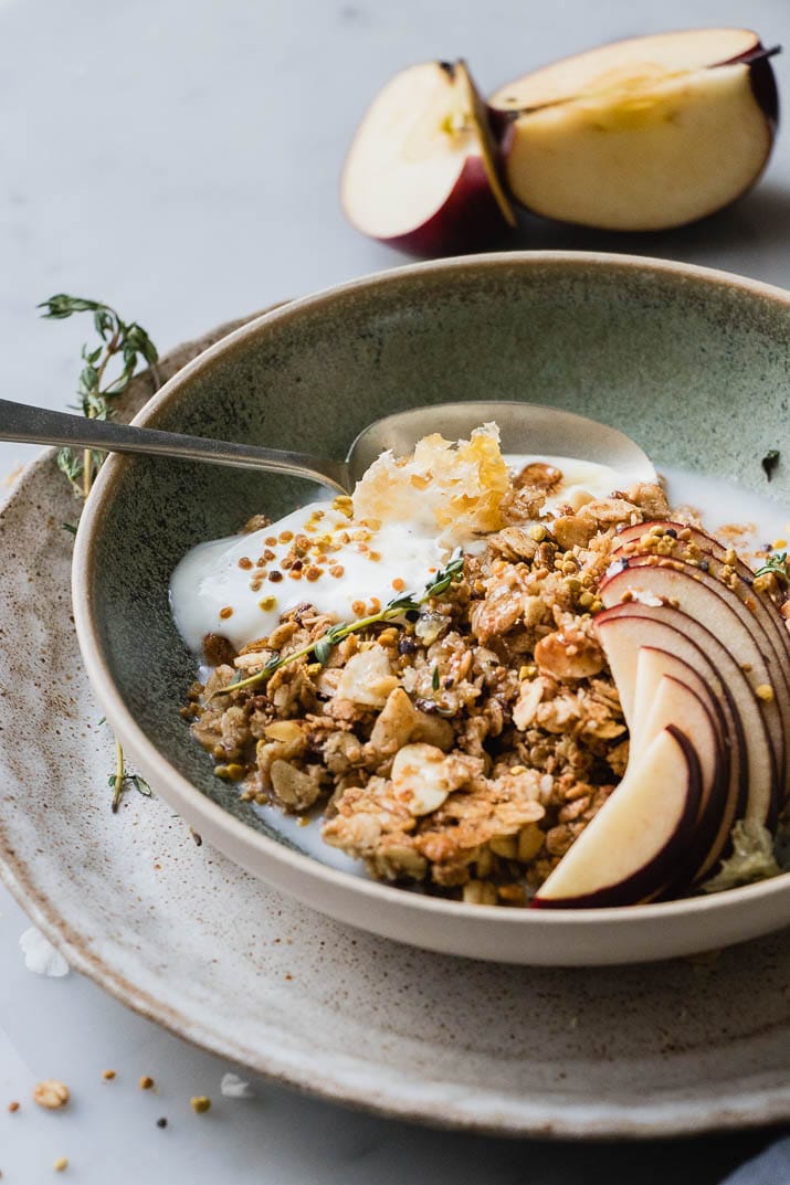 Warm Granola Breakfast Bowl is the perfect cozy start to any morning. Healthy oats, sweet, natural maple syrup and toasted almonds and coconut. These are the winter equivalent of a warm hug on a cold day.