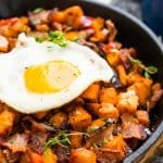 This Sweet Potato Hash is loaded with onions, peppers, bacon, and seasonings and topped with eggs for a delicious and hearty breakfast recipes!