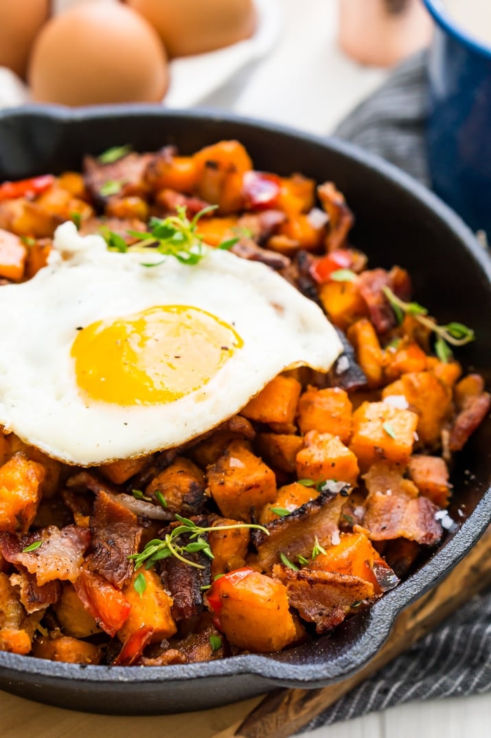 This Sweet Potato Hash is loaded with onions, peppers, bacon, and seasonings and topped with eggs for a delicious and hearty breakfast recipes!