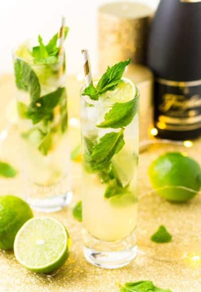 This Champagne Mojito Recipe is a bubbly twist on the classic cocktail making it perfect for parties and celebrations. Made with fresh limes, mint, simple syrup, rum, and champagne, everyone will love this zesty and refreshing cocktail!