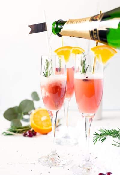  This Cranberry Orange Mimosa is the perfect cocktail for winter brunch! Made with cranberry and orange juice and champagne it's a fruity drink that you can serve up for Christmas or New Year's Eve or any other weekend celebration!