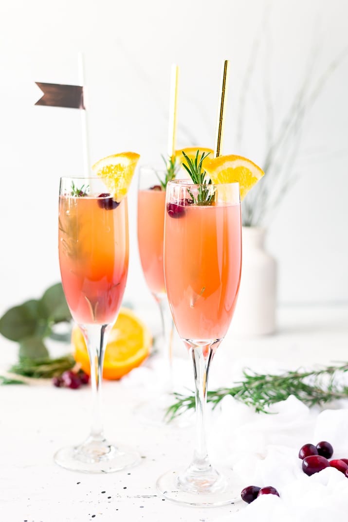 This Cranberry Orange Mimosa is the perfect cocktail for winter brunch! Made with cranberry and orange juice and champagne it's a fruity drink that you can serve up for Christmas or New Year's Eve or any other weekend celebration!