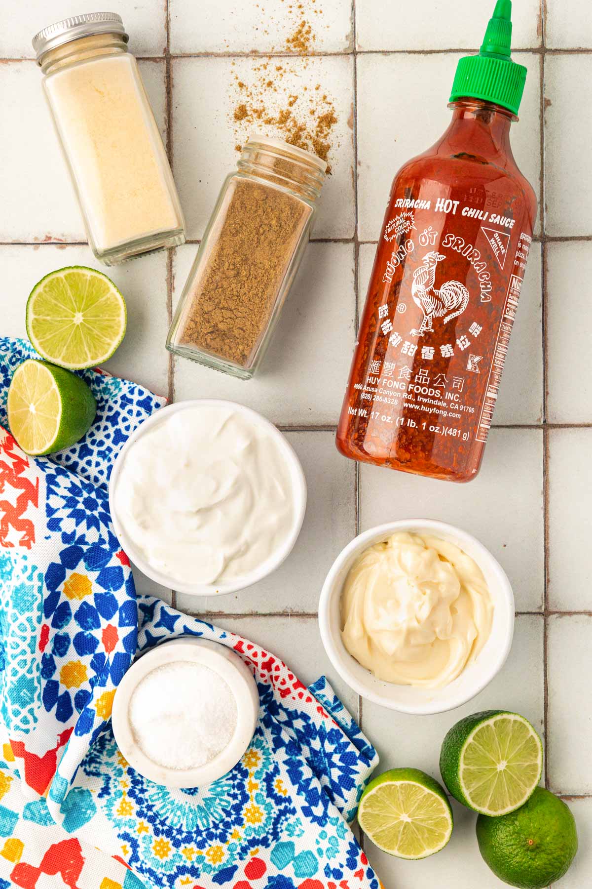 Overhead photo of ingredients to make fish taco sauce on a table. 