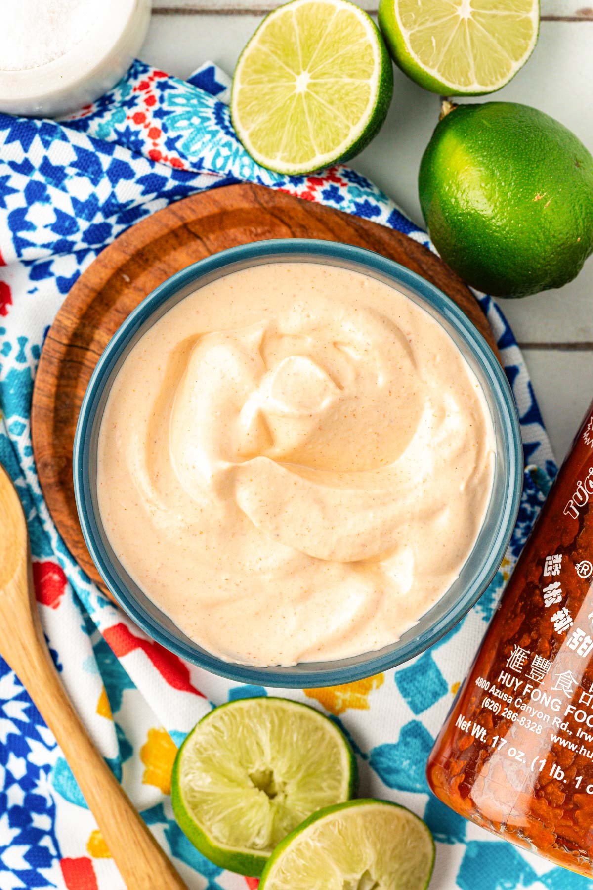 A blue bowl filled with creamy fish taco sauce. 