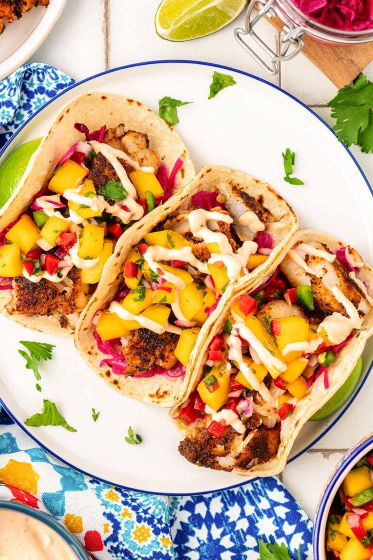 Overhead photo of three tacos on a plate.