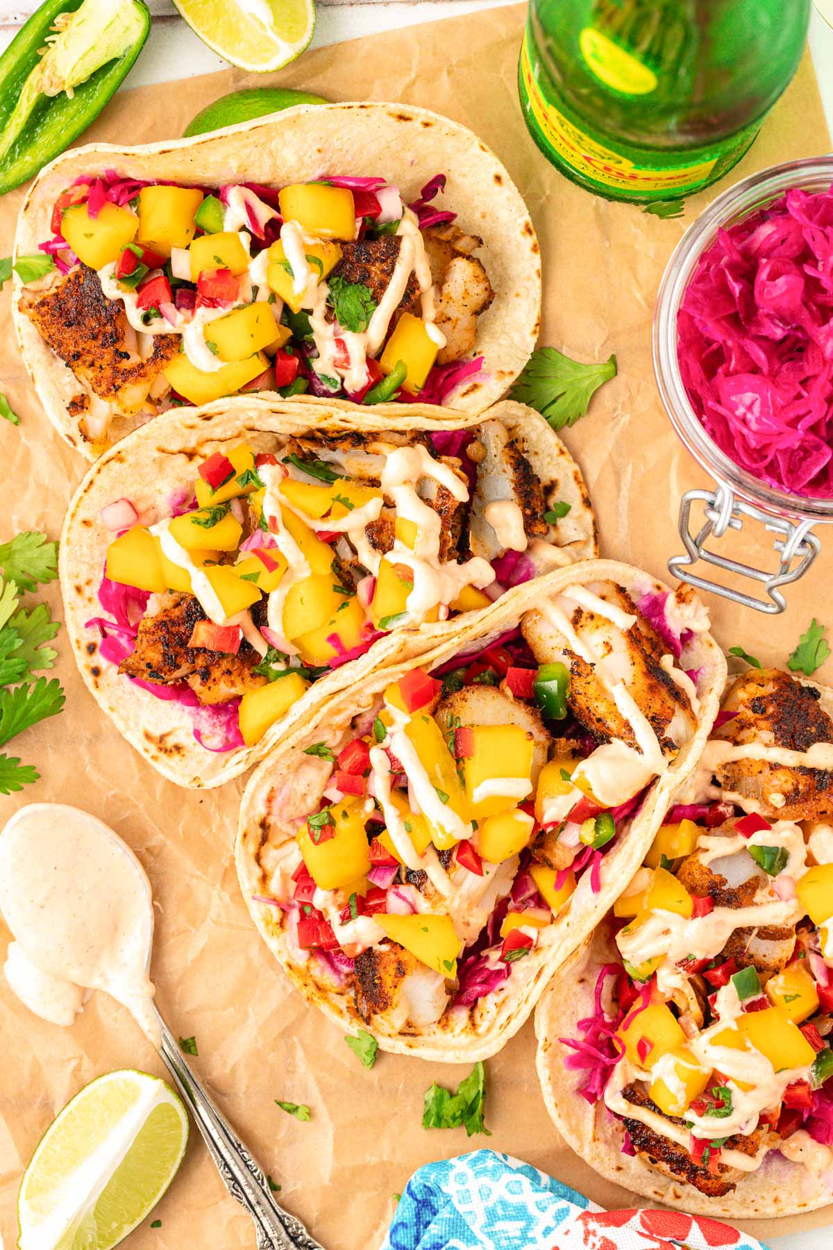 Overhead photo of 5 cod fish tacos on a table.