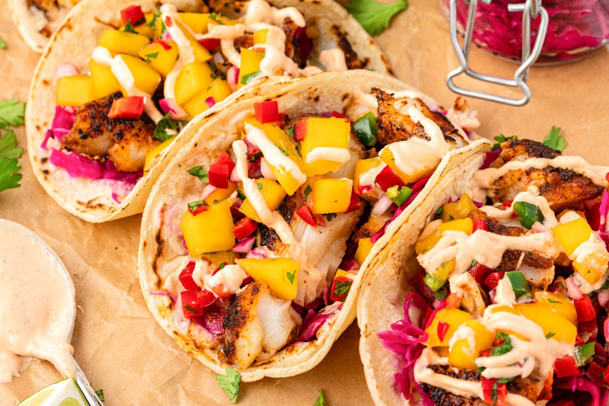 Blackened cod tacos on a piece of parchment paper.