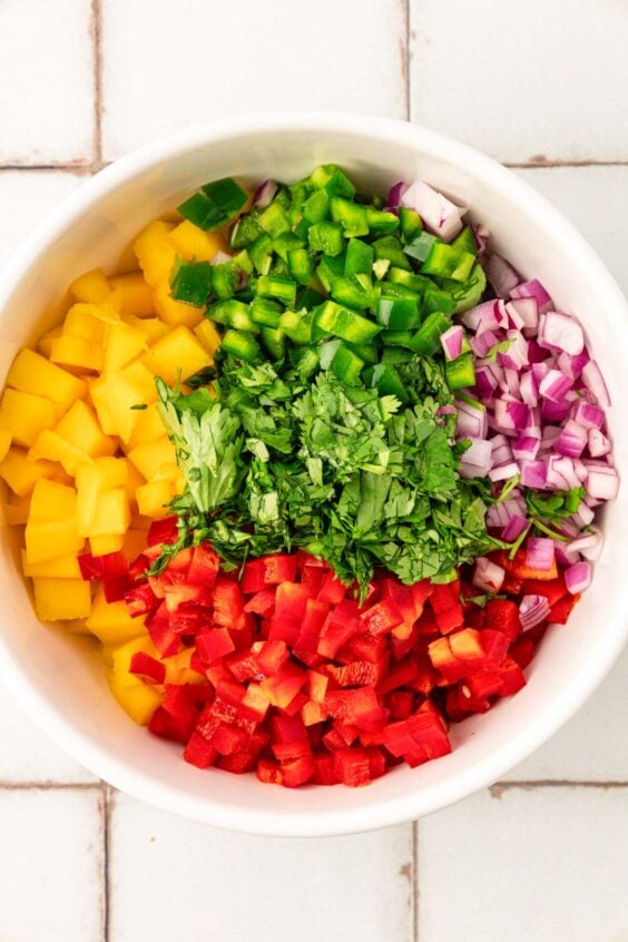 Ingredients in a bowl to make mango salsa.