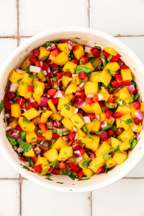 Mango salsa in a white bowl.