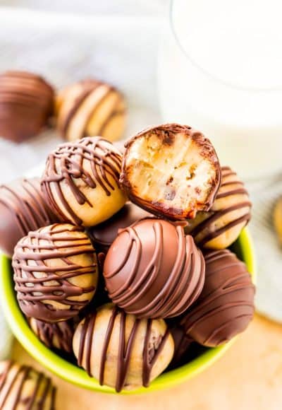 These Cookie Dough Truffles are easy to make, safe to eat, and totally addictive! These chocolate covered treats perfect for parties, game days, or to satisfy cravings any time of the day or night.