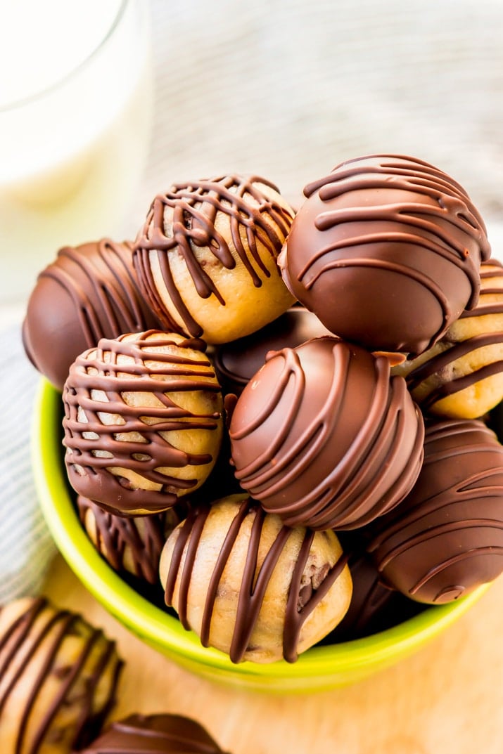 These Cookie Dough Truffles are easy to make, safe to eat, and totally addictive! These chocolate covered treats perfect for parties, game days, or to satisfy cravings any time of the day or night.