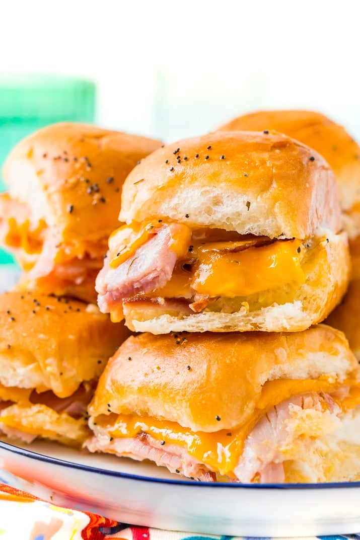 This Ham and Cheese Sliders Recipe is the ultimate EASY game day dish or weeknight dinner! Made with simple, family-favorite ingredients, these sliders made with honey ham and melted cheddar cheese will have everyone begging for seconds!