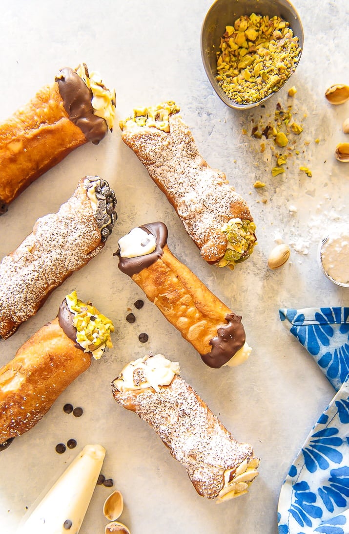 Overhead photo of cannoli on a white table.