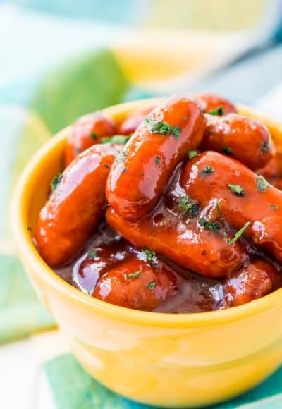 These Peach Barbecue Little Smokies are going to be an instant game day party hit! Made in the slow cooker with barbecue sauce, peach preserves, and cayenne pepper, it’s an addictive appetizer recipe everyone will love!
